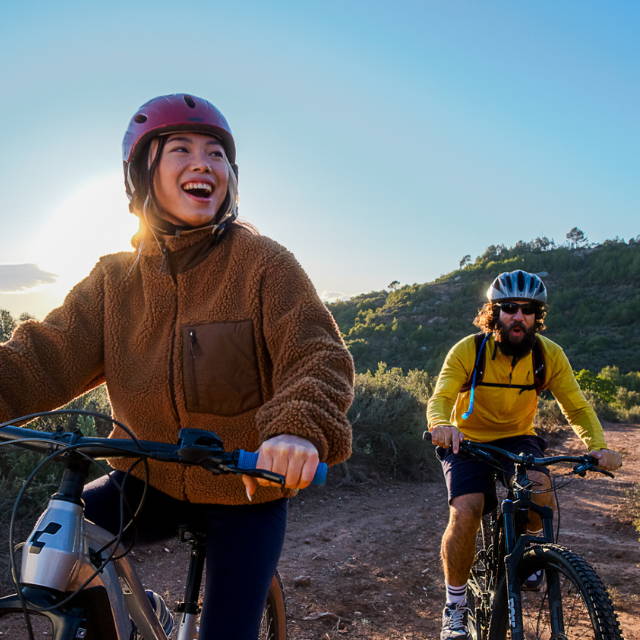 a man and a woman e-biking in the wilderness