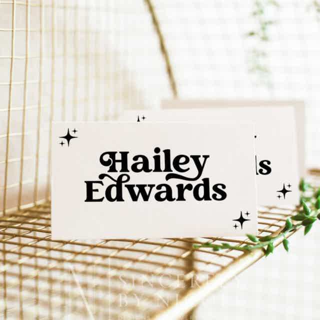Retro place card featuring a 70s-style font, elegantly displayed on a gold wire stand