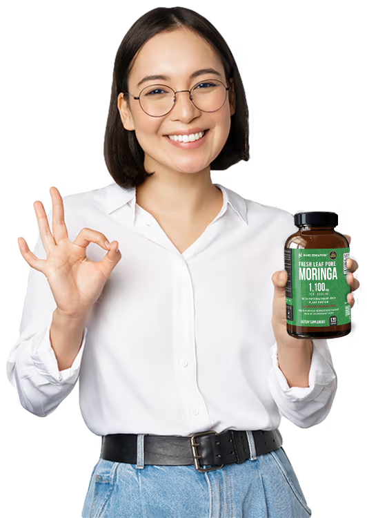 Woman holding up a bottle of the best moringa supplement