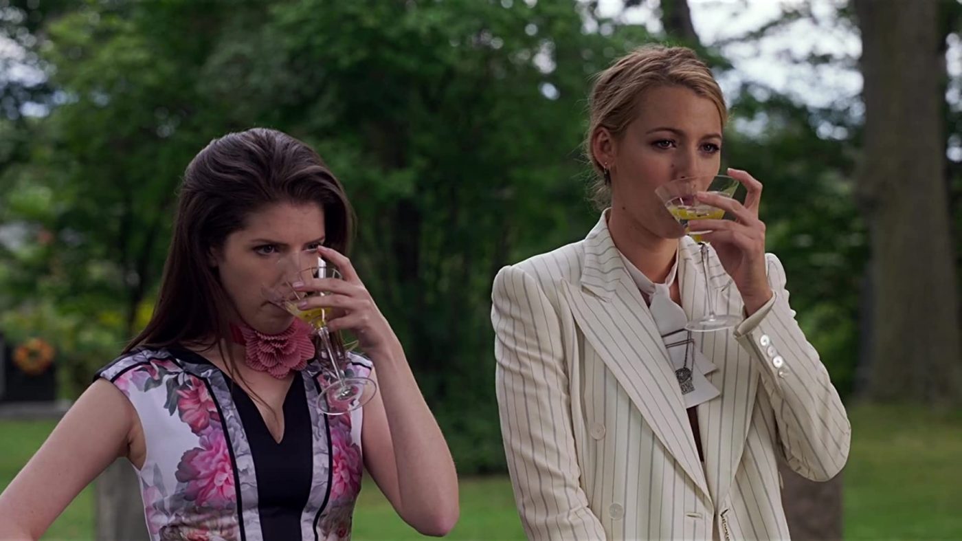 Image of Stephanie and Emily, looking worried in side by side, drinking their martini's quickly.