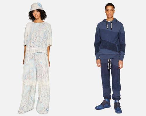 Woman wearing wide leg trousers, matching half sleeve top and bucket hat all made from recycled silk map fabric and man wearing organic cotton blue asymmetric stripe hoodie and sweatpants with Raeburn branding