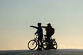Deux personnes avec leurs vélos électriques regardant l'horizon