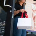 woman walking out with an ewc bag