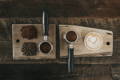 light and dark roast with a prepared espresso shots and coffe on a wooden board