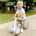 Little boy riding outside on his Montessori Baby Balance Bike. 