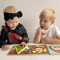 Little girl and her brother playing with the Montessori Toddler Xmas Puzzles.