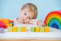 Toddler playing with educational Montessori toys. 