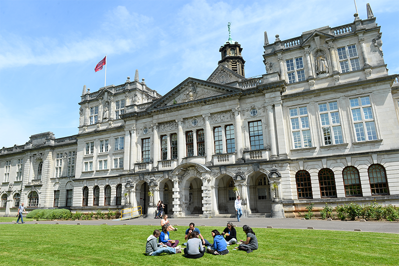 Students sat on the lawn outside the main Cardiff University campus building