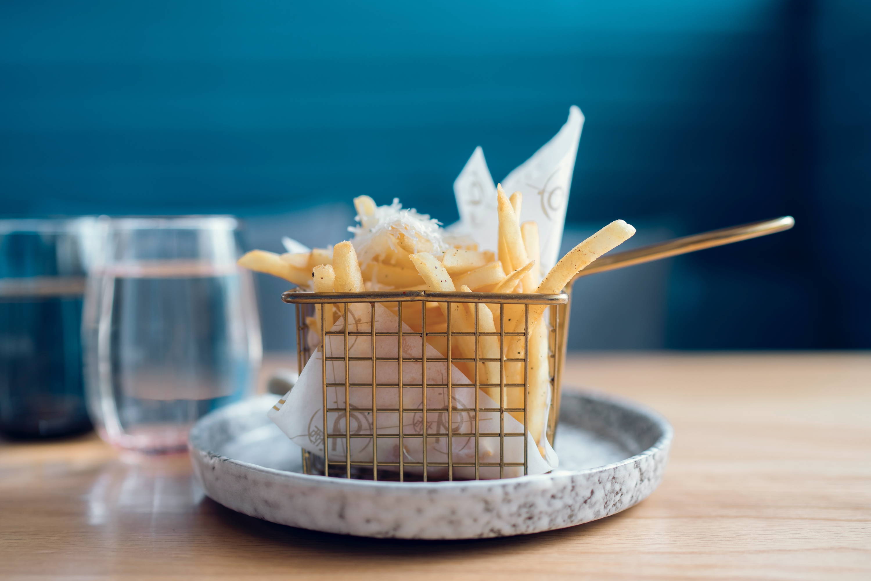 Simple plate of chips topped with grated sea sat to pair with our Chill or Zesty Sparkling Kiss of Wine wines.