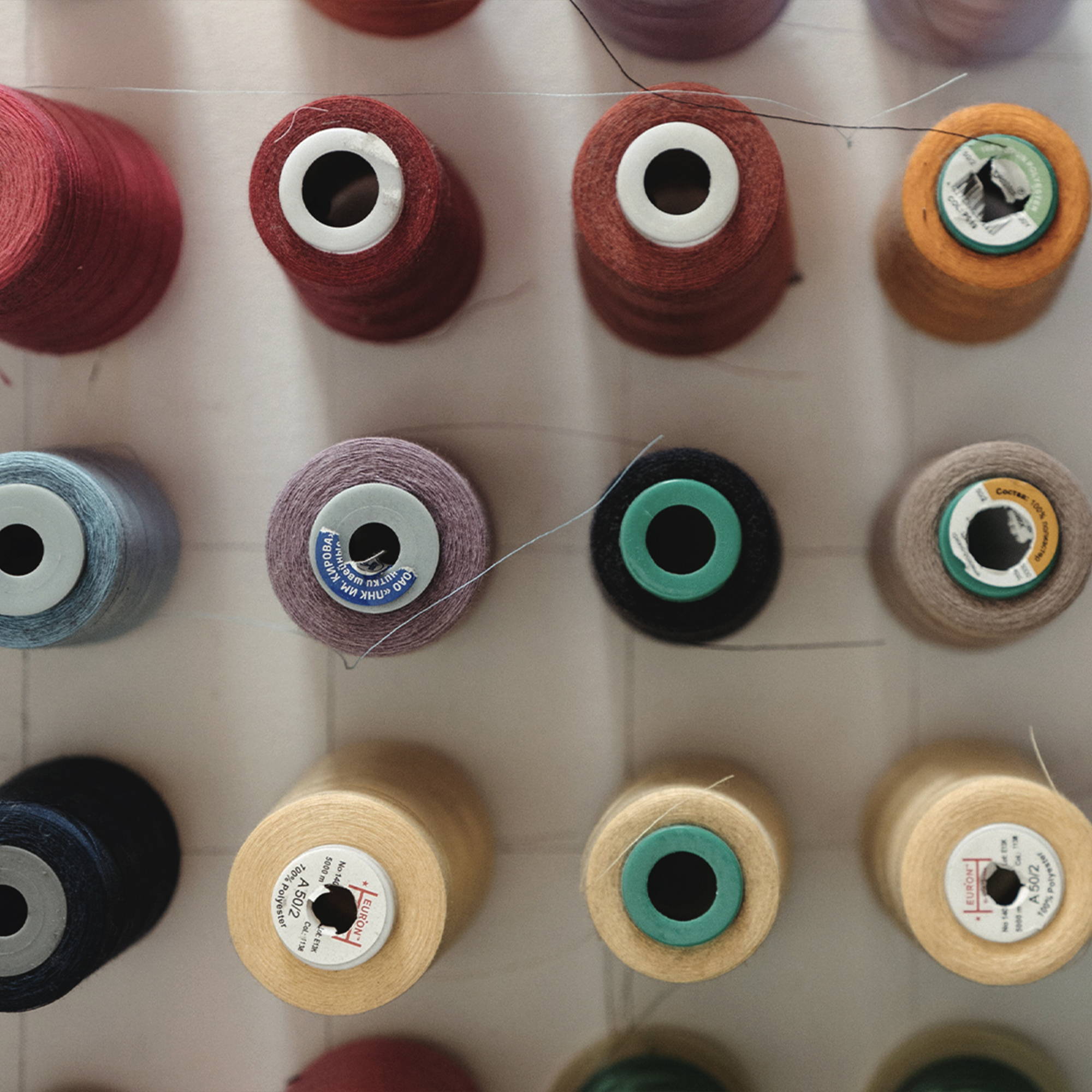 Rows of colorful spools of thread.