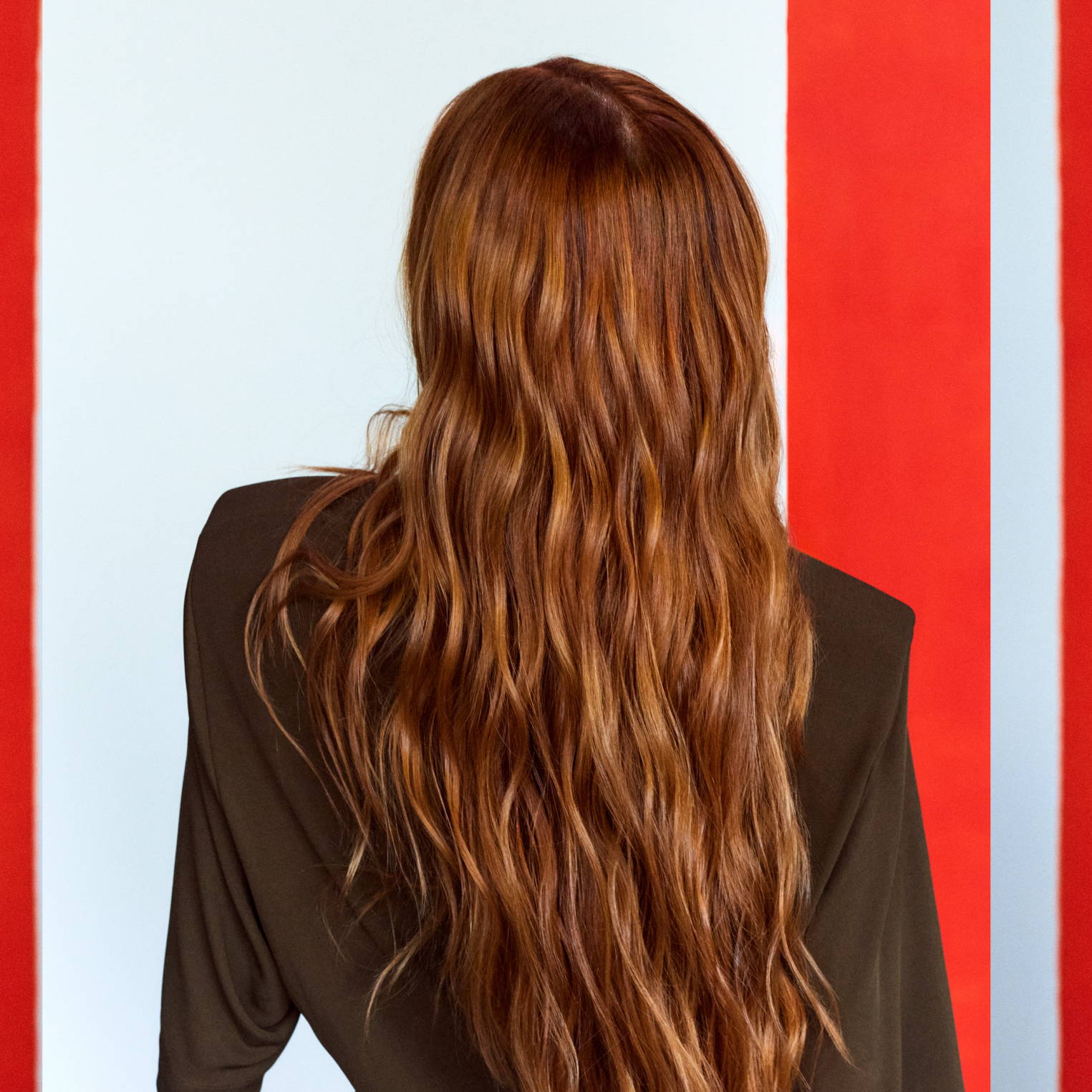 Davines model with long, wavy red hair