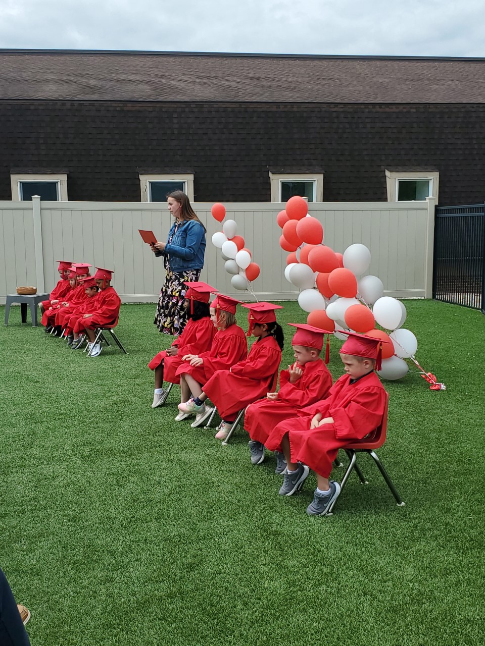 Miss Alexis  congratulates the newly graduated Kindergarten Class 