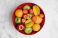 Bowl of fresh fruits in water on a table