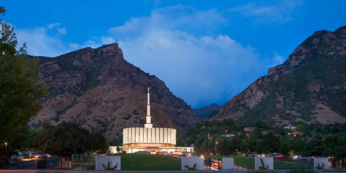 Provo Temple glowing against the night sky. 