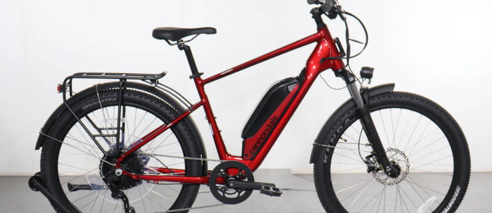 a red Cannondale Adventure Neo Allroad Speed front suspension electric mountain bike