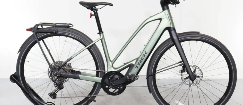 a light green Trek FX+ 7S electric city bike