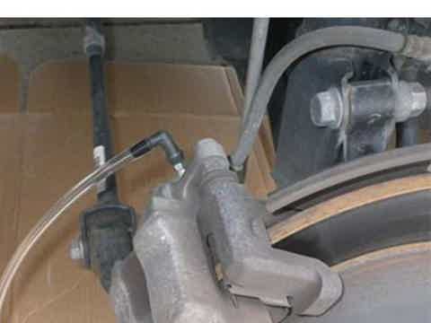 vacuum brake bleeder kit connected to brake bleeder screw
