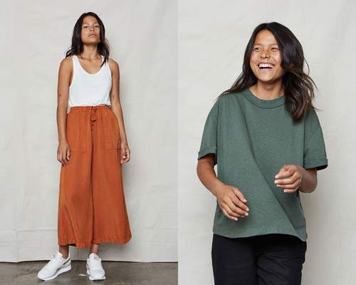 Woman wearing ochre orange Tencel wide leg trousers with white sports trainers and white vest top and woman wearing army green boyfriend fit organic cotton and hemp t-shirt from sustainable womenswear brand Back Beat Rags