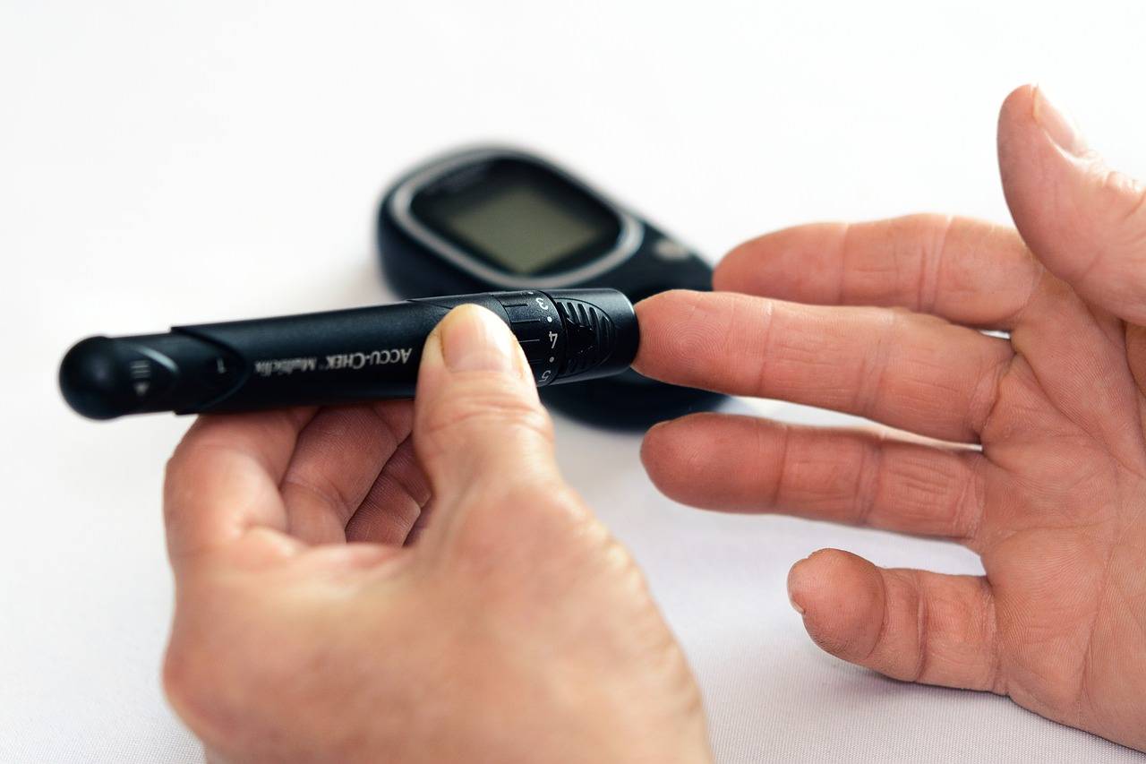 Man taking blood level sugar test