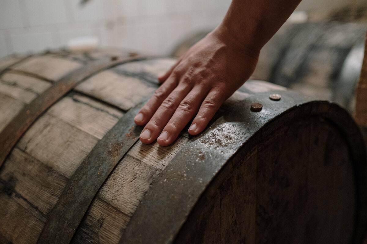 Hand on a barrel demonstrating the importance of the fermentation phase that create the flavours in the wine. 