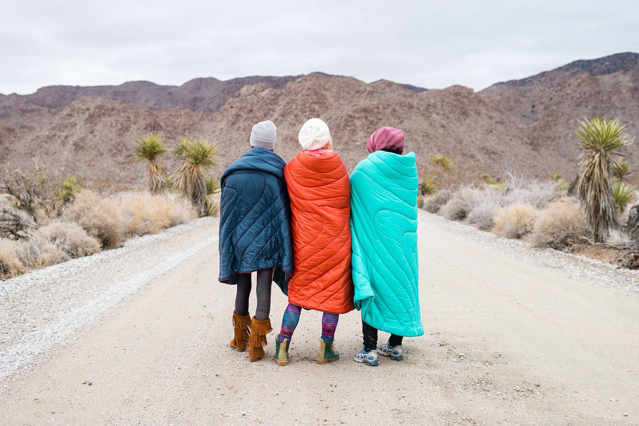 Group of three women standing in Rumpl blankets in Joshua Tree National Park