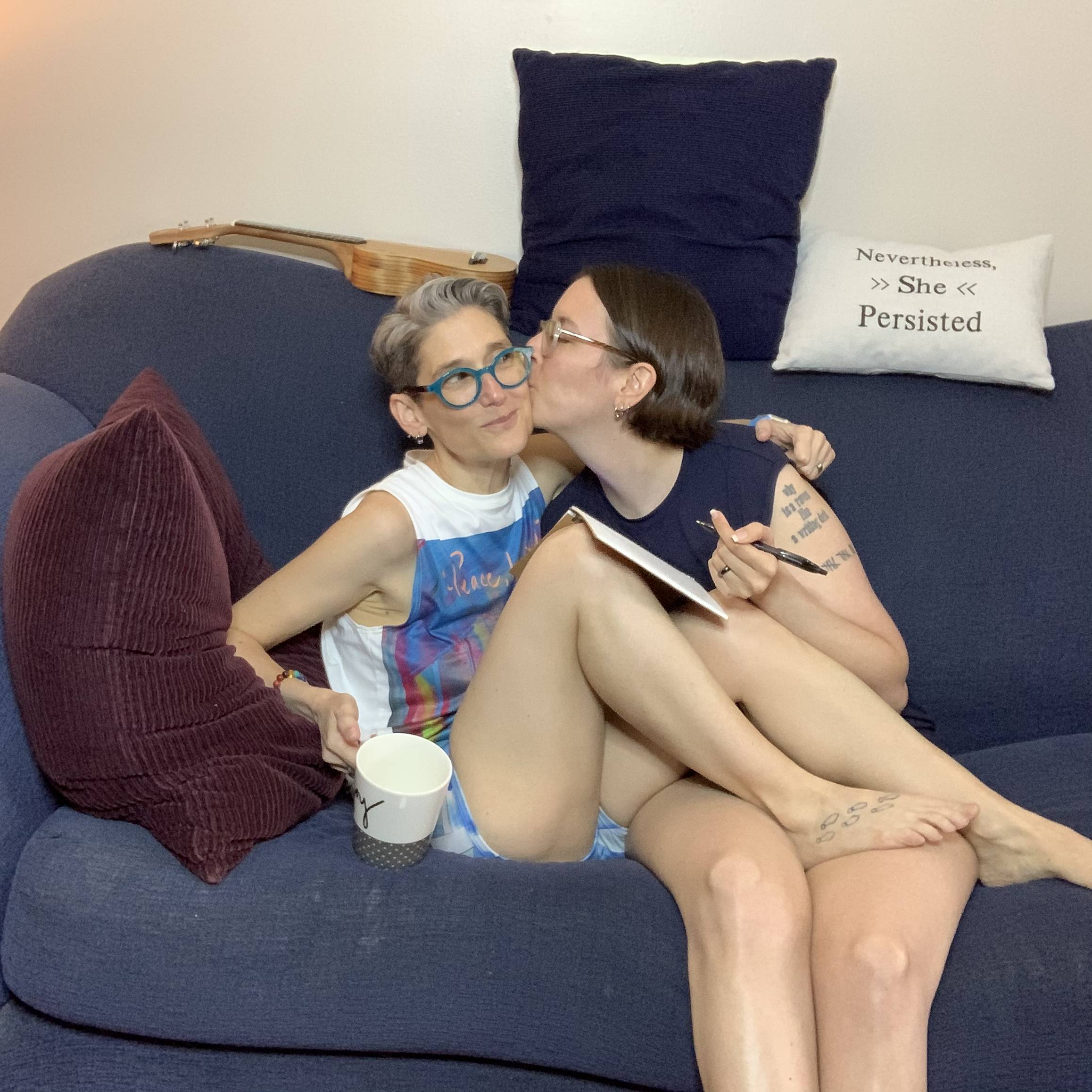 Dapper Mindy and Megan cuddle on the sofa wearing Play Out gender equal muscle T's and underwear.