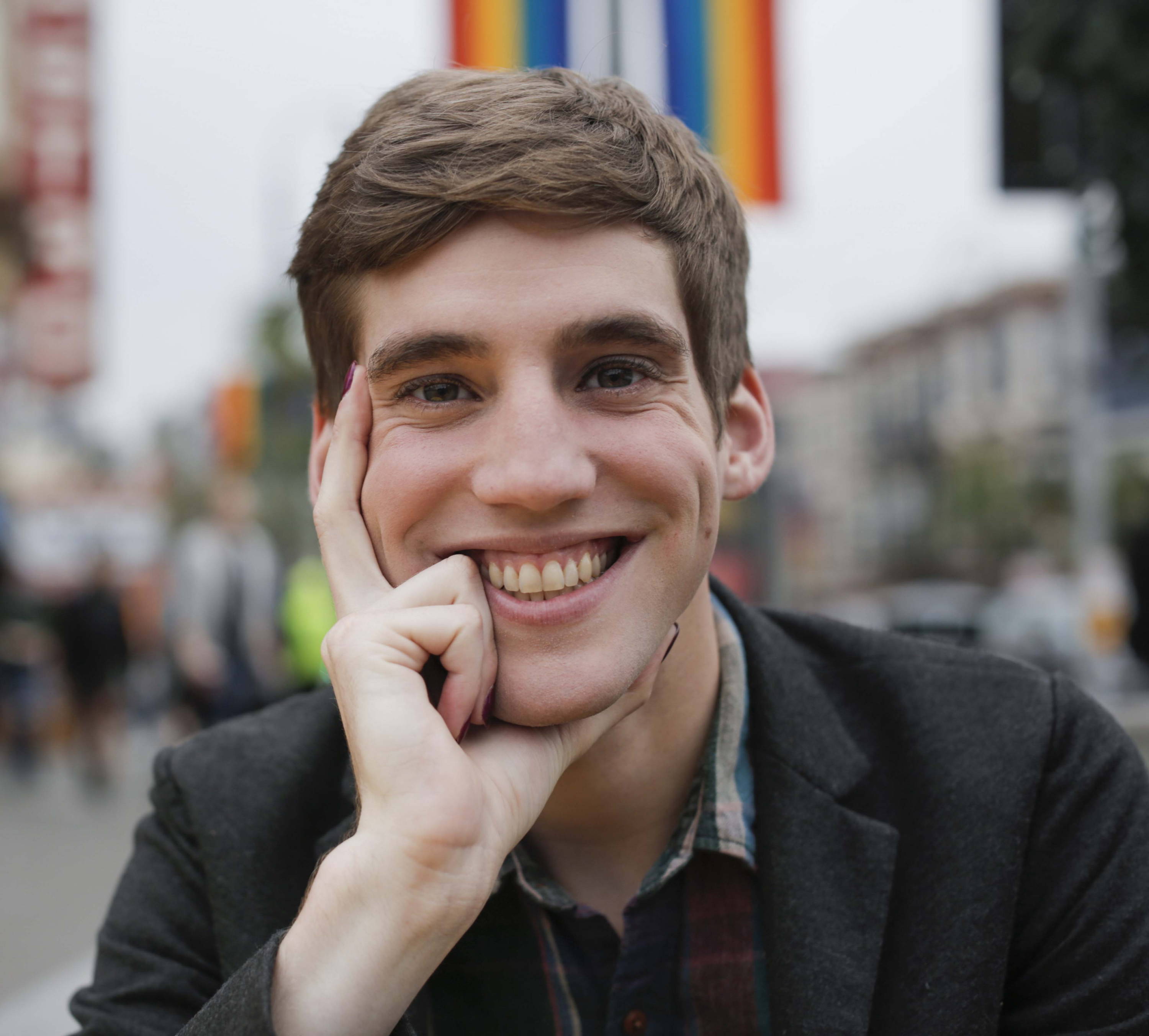 Nonbinary influencer and tech queer Kylé Graden smiles at the camera.
