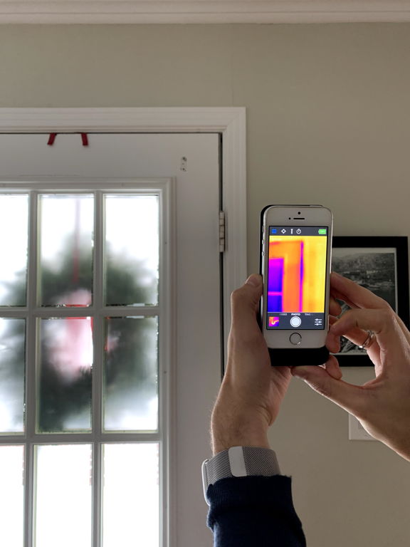 smartphone reading temperature of glass pane door