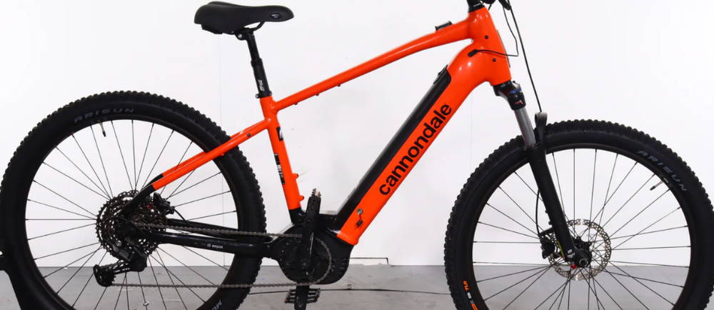 A red Cannondale Trail Neo 3 front suspension electric mountain bike