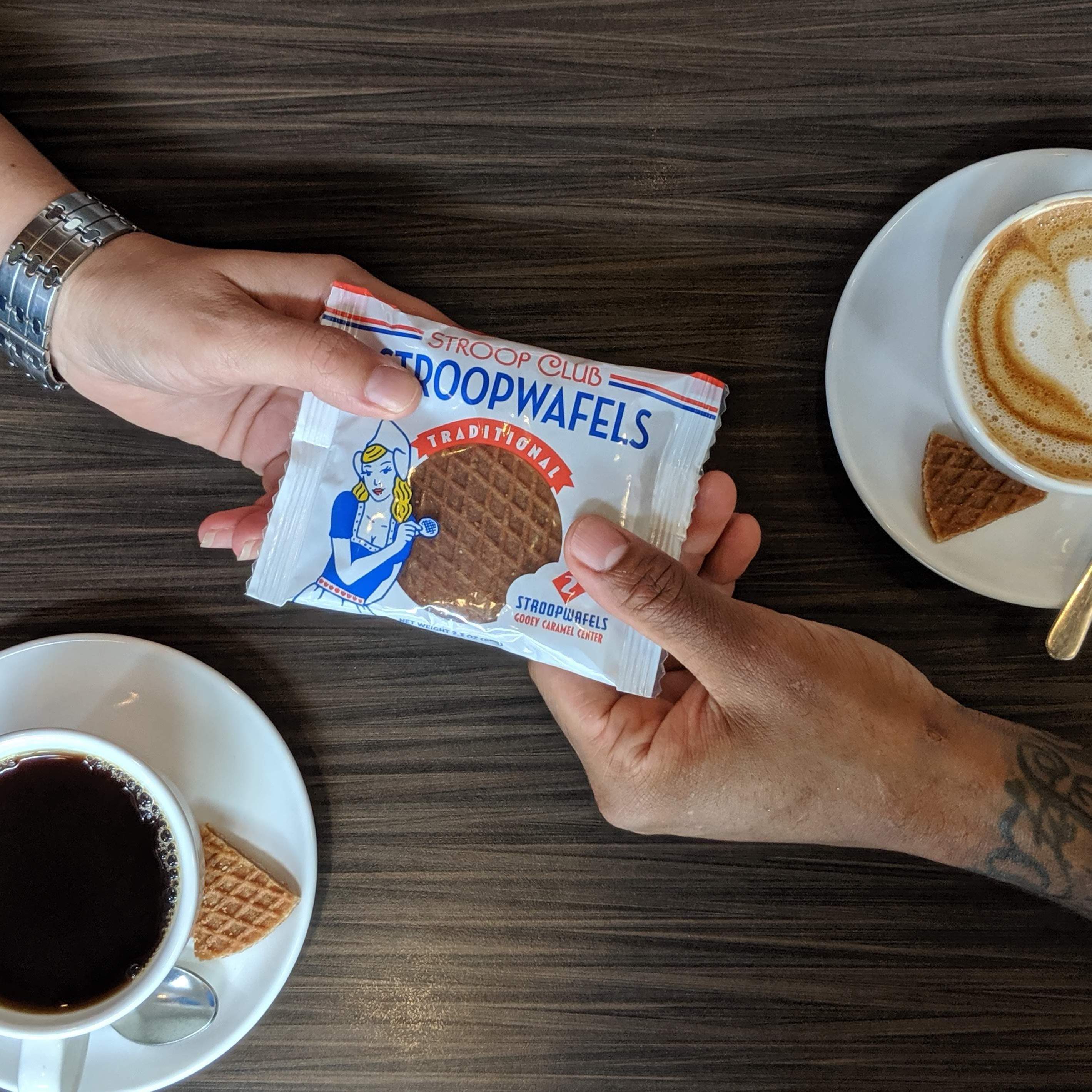 Picture of a stroopwafel being handed to someone