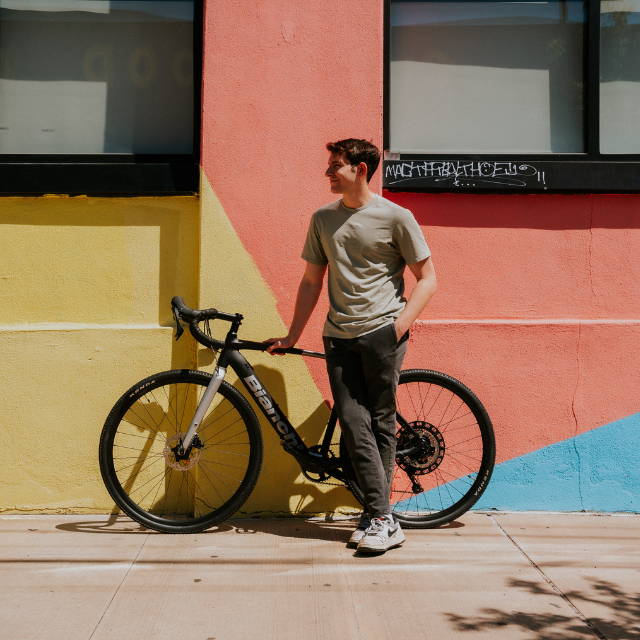 a man next to his Bianchi road bike