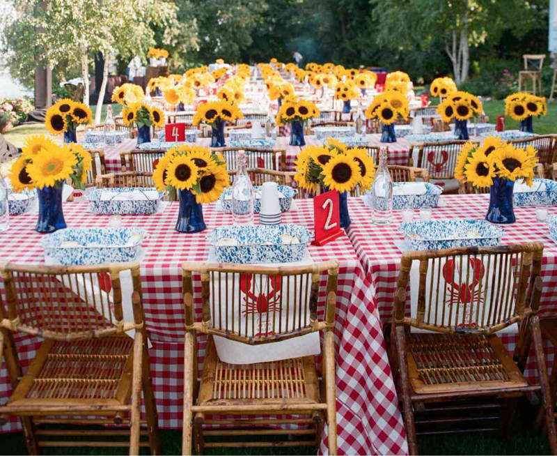 poly checkered tablecloths over several tables with sunflowers over them