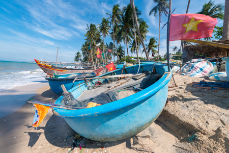 Vietnamese fishing coracles on beach, tribal boats at fishing village.jpg