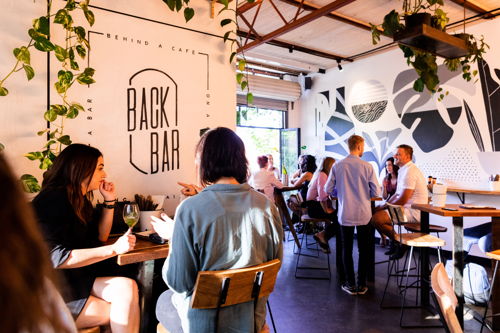 'Back Bar' - A bar behind a cafe on a road along a train line.