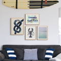 A set of coastal art prints above a sofa in a living room. Gallery wall art prints in living room
