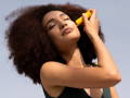 Woman applying a stick on her face
