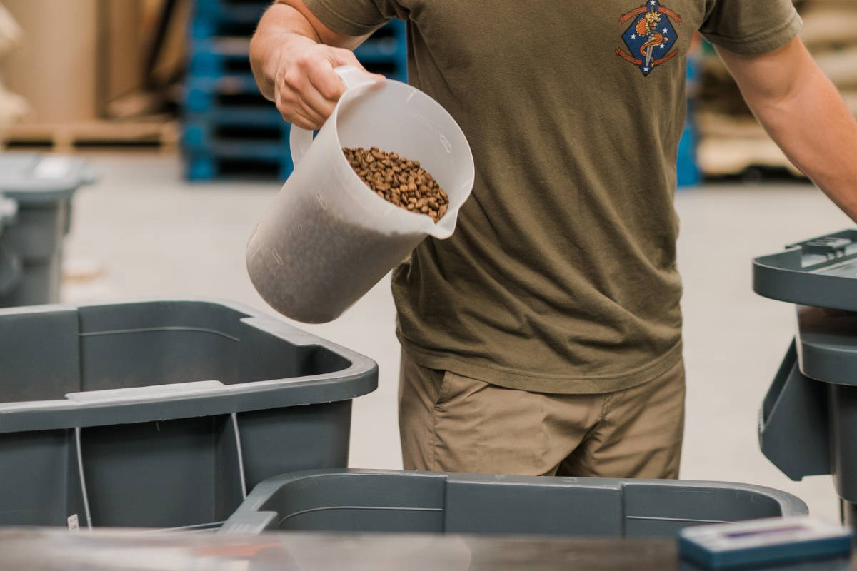 Man dumping whole bean coffee into trash