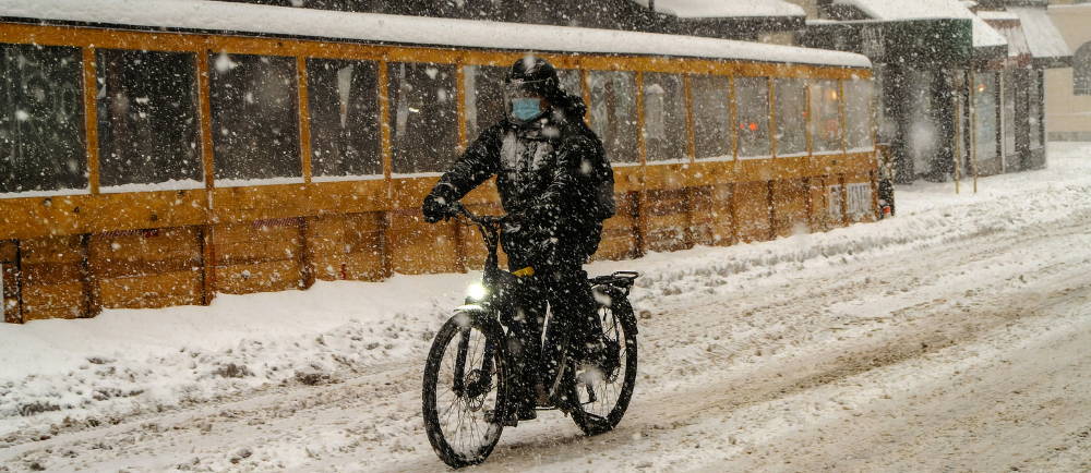 Electric bike rider on snowy road