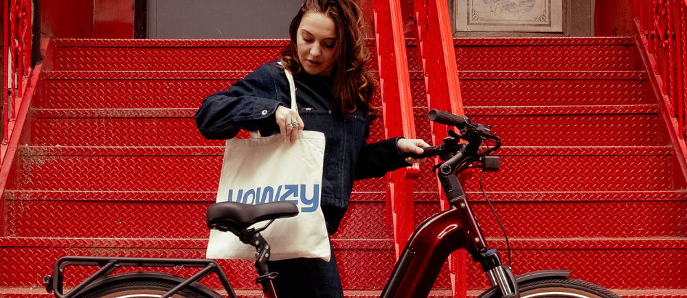 woman with an electric bike in front of the stairs