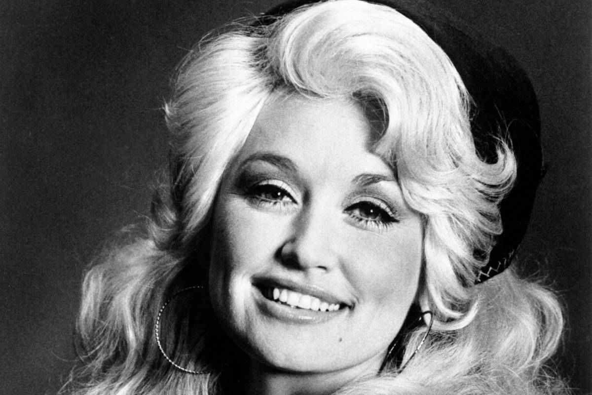 Image may contain: Dolly Parton, Face, Head, Person, Photography, Portrait, Happy, Smile, Blonde, Hair, and Adult