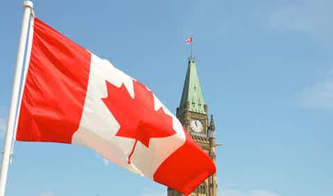 Canadian flag waving in front of the Peace Tower at Ottawa