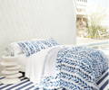 Navy and white bedding with leaf pattern