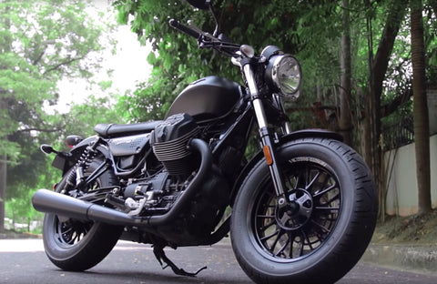 Front view of the Moto Guzzi V9 Bobber showing its distinctive headlight and handlebar design