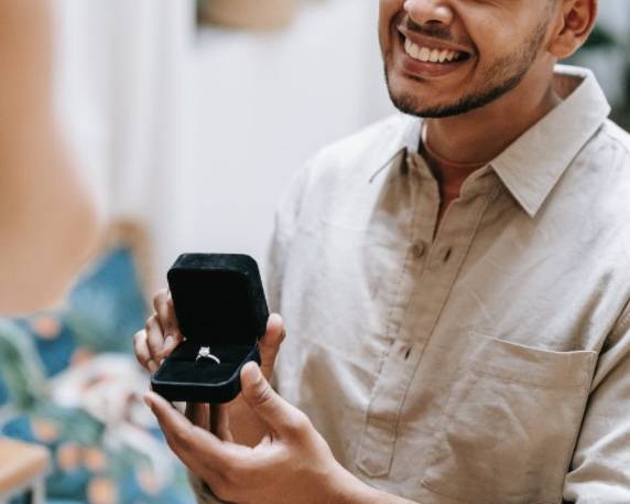 man propsing showing a 4.5 ct diamond engagement ring