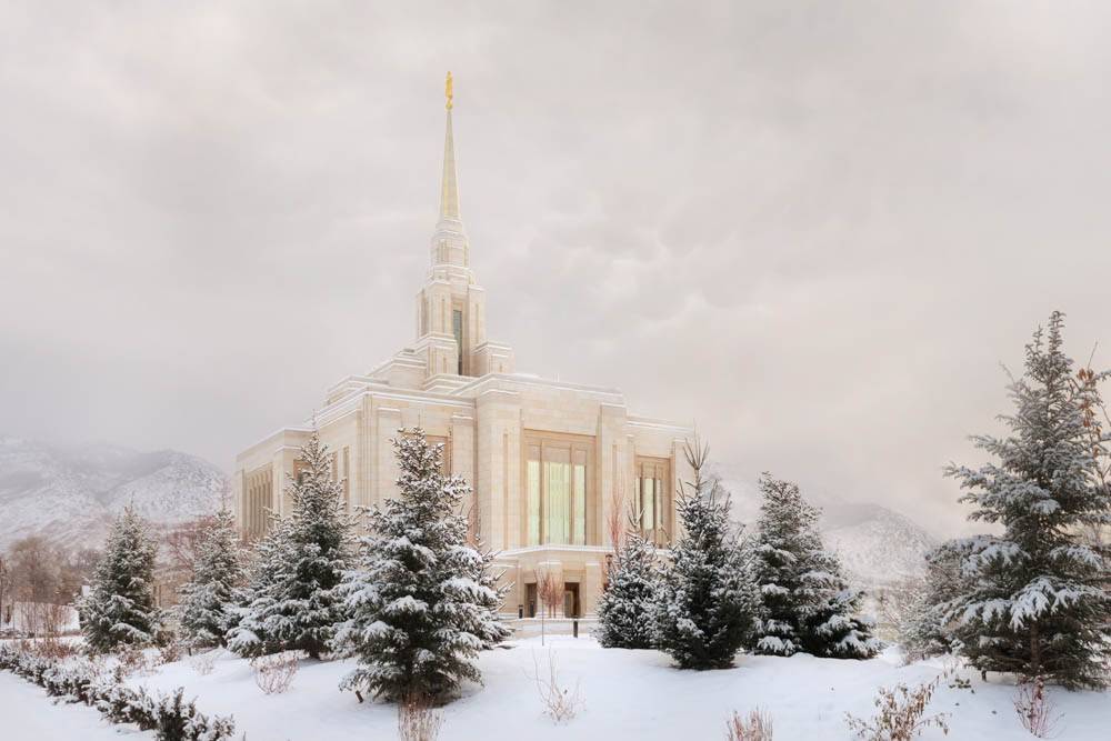 Angled photo of the Ogden Temple amid snowfall.