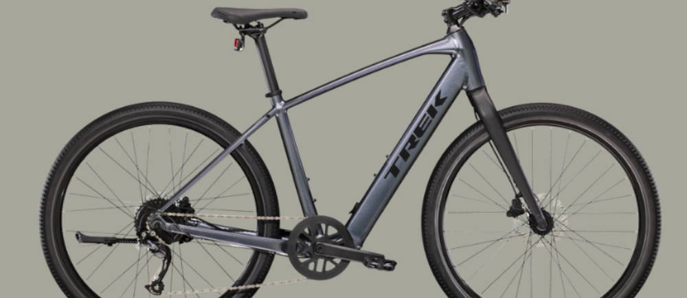 a silver Trek Dual Sport+ 2 electric city bike