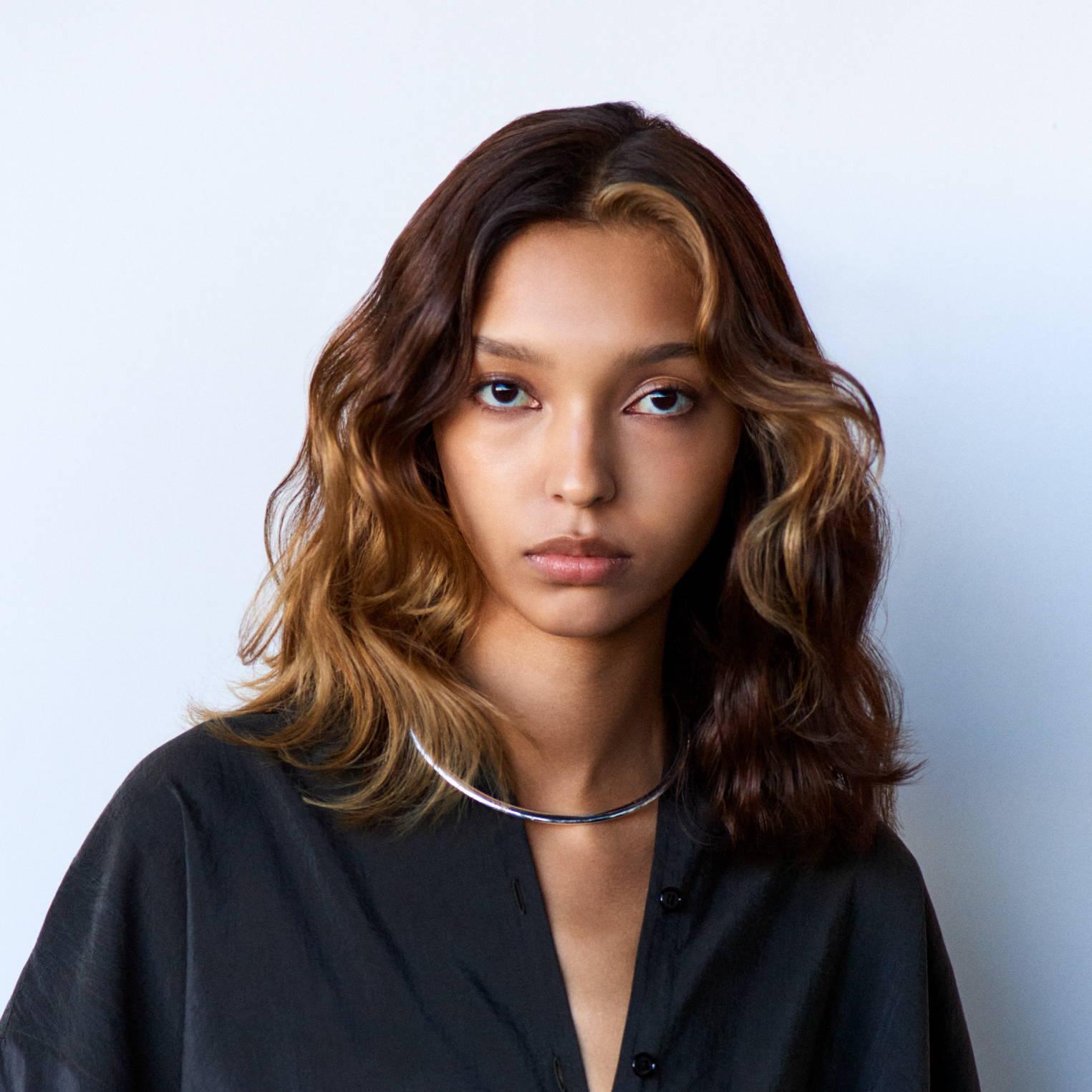 Davines The Present Time hair model with shiny, medium-length brown hair