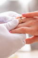 Jewelry Consultant holding ring bearers hand