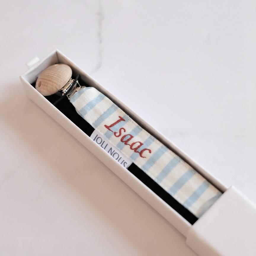 Attache-tétine lolette doudou anneaux dentitions marque suisse Joli Nous, un accessoire premium pour bébé, alliant design raffiné et qualité exceptionnelle