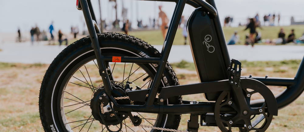 closeup of the rear wheel and battery of an e-Bike